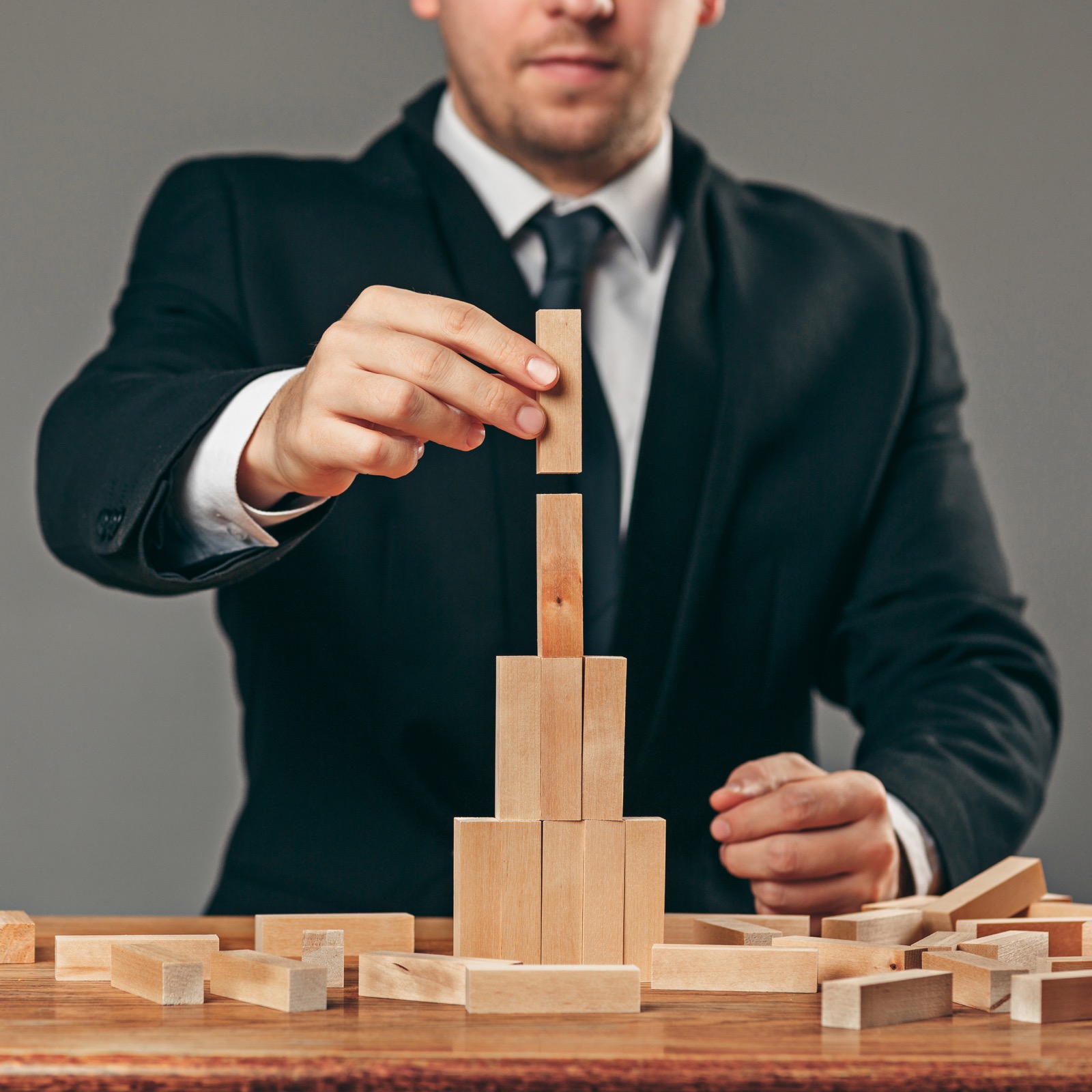 Businessman stacking wooden blocks